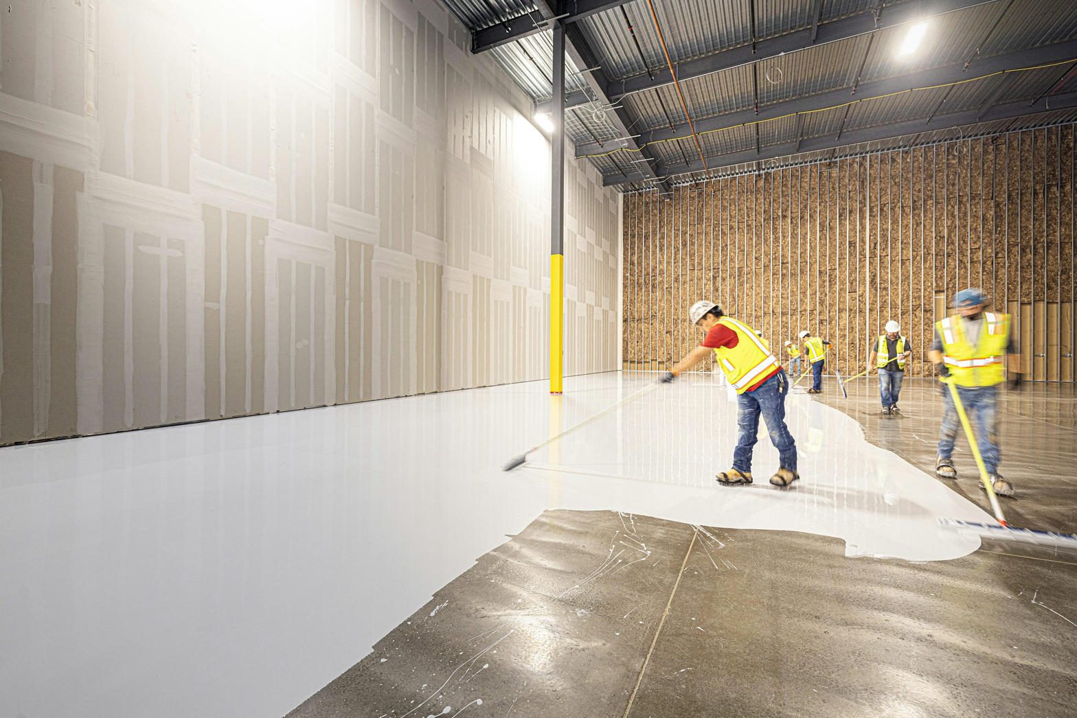 Floor coating in progress on a garage slab
